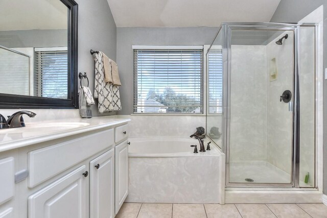 bathroom featuring tile patterned floors, a shower stall, vanity, and a bath