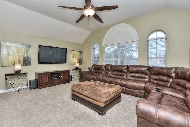 living area featuring lofted ceiling, carpet flooring, and a ceiling fan