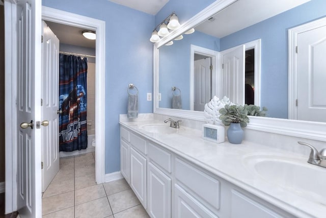 bathroom with a sink, curtained shower, double vanity, and tile patterned flooring