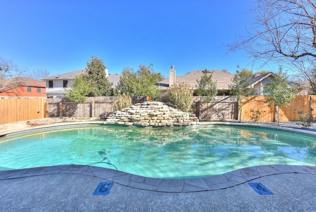 view of swimming pool featuring a fenced backyard and a fenced in pool