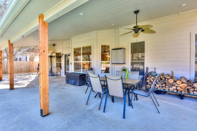 view of patio / terrace with ceiling fan, outdoor dining space, and fence