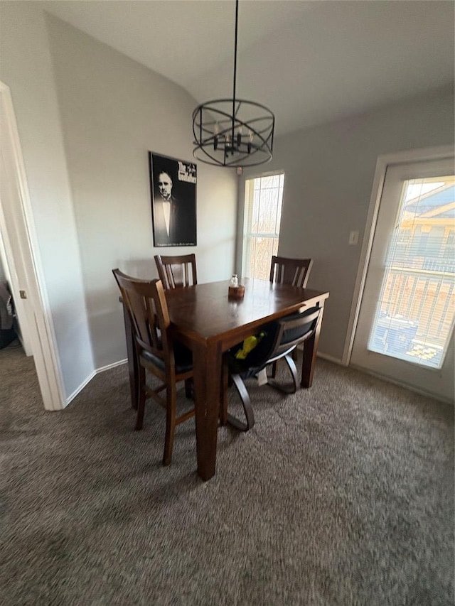 dining room with vaulted ceiling, a notable chandelier, baseboards, and dark carpet