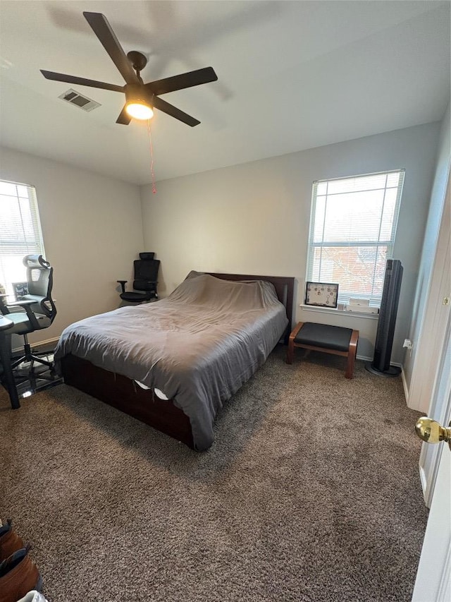 bedroom with visible vents, carpet flooring, baseboards, and ceiling fan