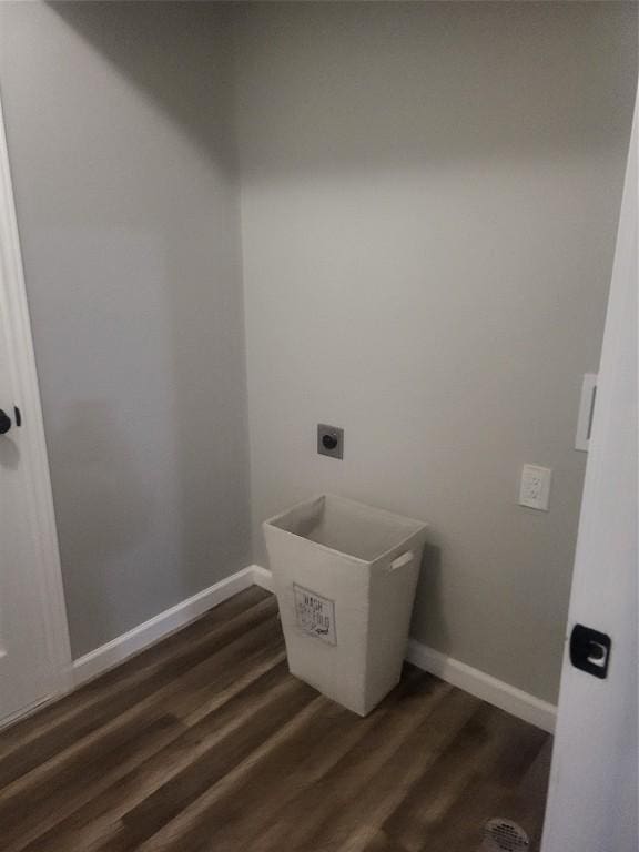 laundry area with laundry area, hookup for an electric dryer, baseboards, and wood finished floors