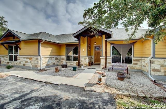 craftsman-style house featuring stone siding