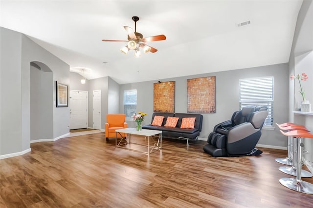 2700 Tumbling River Dr, Leander, TX 78641 - living area featuring arched walkways, a ceiling fan, wood finished floors, and vaulted ceiling