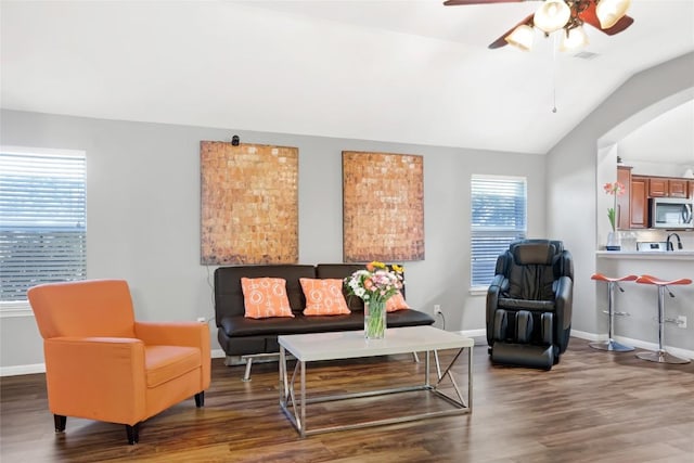 2700 Tumbling River Dr, Leander, TX 78641 - living room featuring arched walkways, vaulted ceiling, wood finished floors, a ceiling fan, and baseboards