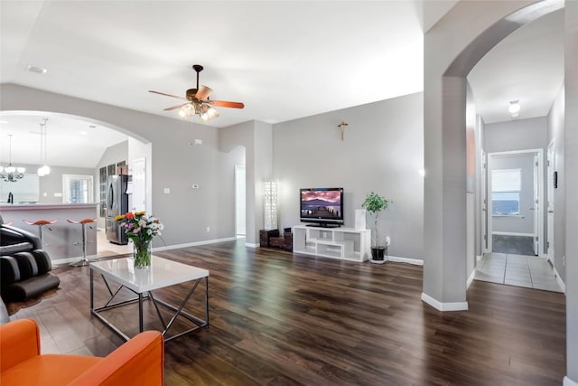 2700 Tumbling River Dr, Leander, TX 78641 - living area featuring lofted ceiling, ceiling fan, baseboards, wood finished floors, and arched walkways