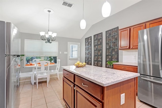 2700 Tumbling River Dr, Leander, TX 78641 - kitchen with freestanding refrigerator, a chandelier, lofted ceiling, a center island, and light tile patterned floors