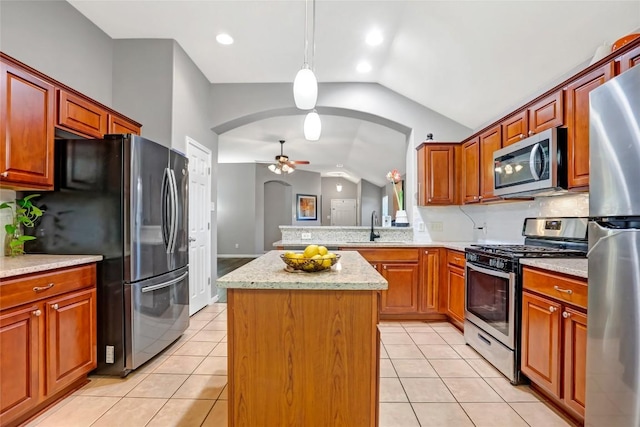 2700 Tumbling River Dr, Leander, TX 78641 - kitchen featuring appliances with stainless steel finishes, arched walkways, vaulted ceiling, a ceiling fan, and a sink