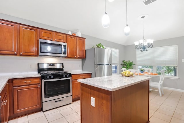 2700 Tumbling River Dr, Leander, TX 78641 - kitchen featuring stainless steel appliances, light tile patterned floors, brown cabinetry, a chandelier, and hanging light fixtures
