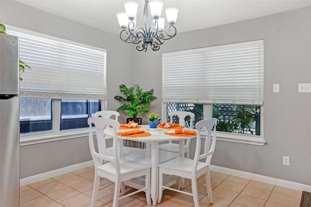 2700 Tumbling River Dr, Leander, TX 78641 - dining space with light tile patterned flooring, a chandelier, and baseboards