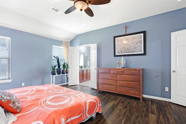 2700 Tumbling River Dr, Leander, TX 78641 - bedroom featuring vaulted ceiling, multiple windows, dark wood-type flooring, baseboards, and connected bathroom