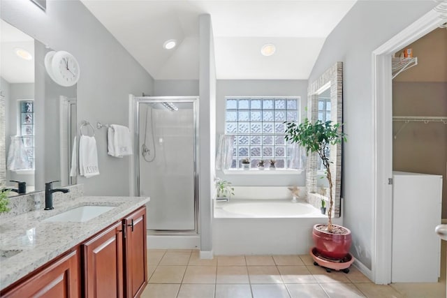 2700 Tumbling River Dr, Leander, TX 78641 - full bathroom featuring a stall shower, a garden tub, vaulted ceiling, double vanity, and tile patterned flooring