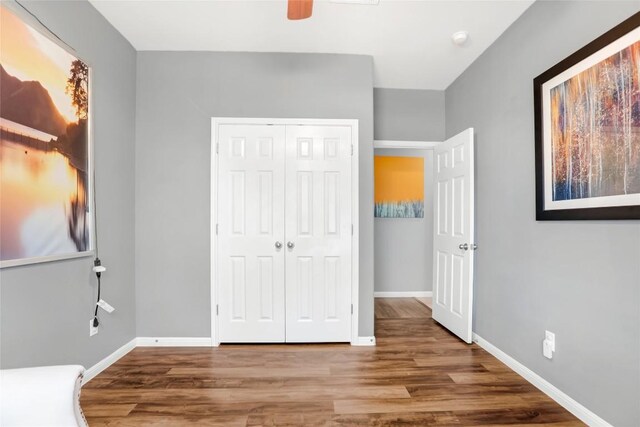 2700 Tumbling River Dr, Leander, TX 78641 - unfurnished bedroom with wood finished floors, a closet, baseboards, and ceiling fan