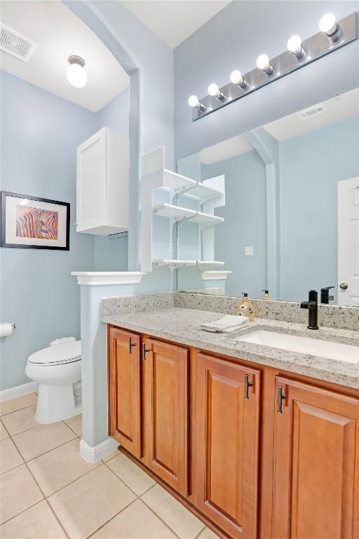 2700 Tumbling River Dr, Leander, TX 78641 - bathroom featuring tile patterned flooring, toilet, vanity, and baseboards