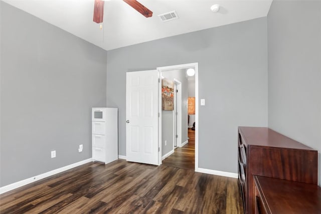 2700 Tumbling River Dr, Leander, TX 78641 - unfurnished bedroom featuring dark wood-style flooring, baseboards, and a ceiling fan