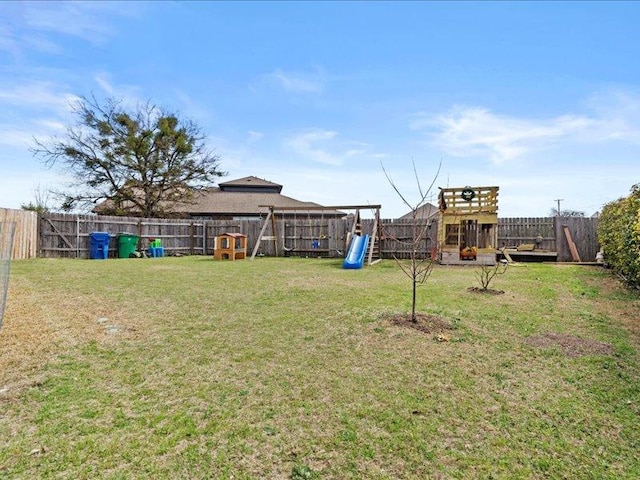 view of yard with a playground and a fenced backyard