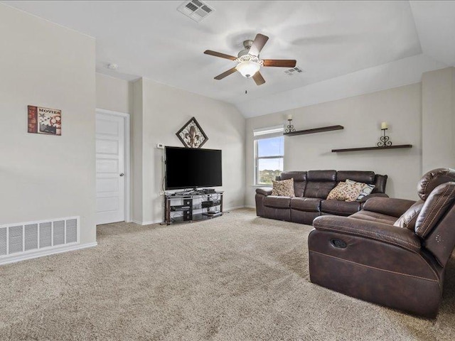 carpeted living room with lofted ceiling, a ceiling fan, and visible vents