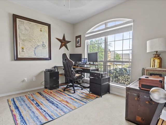 carpeted home office featuring baseboards and a wealth of natural light