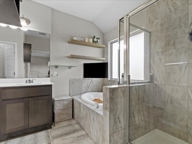 full bathroom featuring vanity, visible vents, vaulted ceiling, a shower stall, and a garden tub