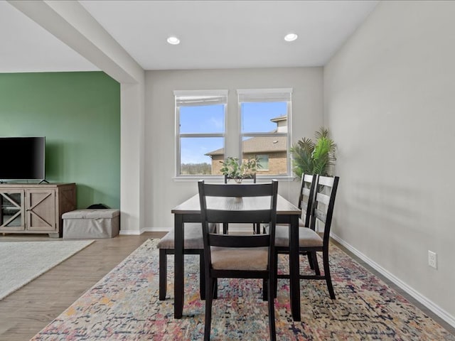 dining area featuring recessed lighting, baseboards, and wood finished floors