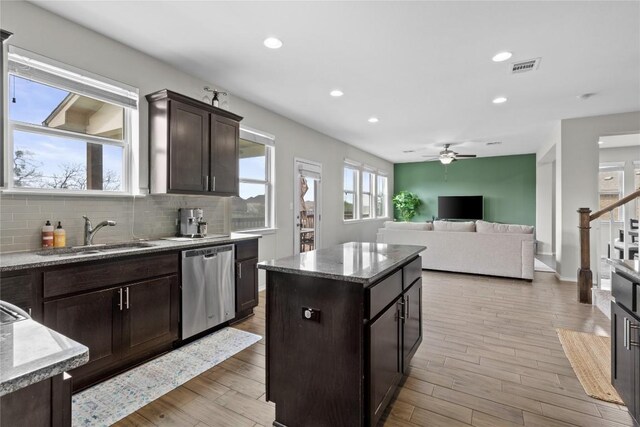 700 Carillion Dr, Pflugerville, TX 78660 - kitchen with visible vents, backsplash, dark brown cabinetry, dishwasher, and a sink