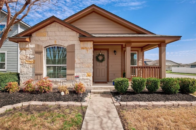 view of front of house featuring a porch and stone siding