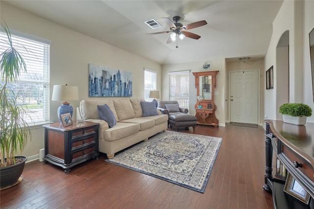 living room with dark wood-style floors, visible vents, and baseboards