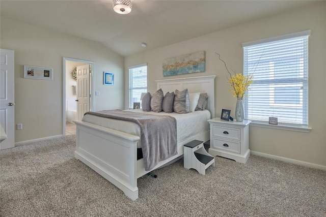 bedroom with light colored carpet, baseboards, and lofted ceiling