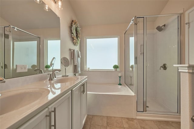 bathroom featuring a sink, a garden tub, and a shower stall