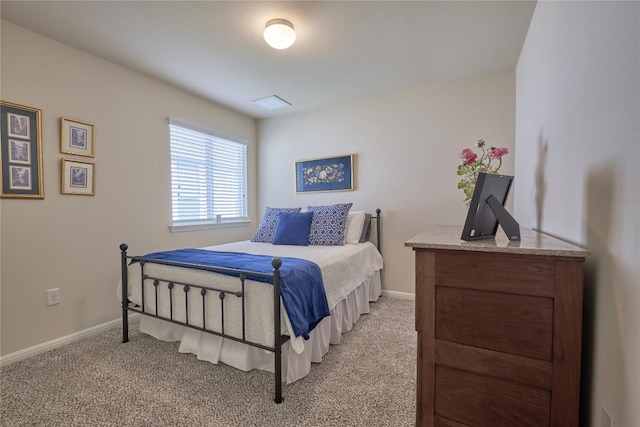 carpeted bedroom featuring baseboards