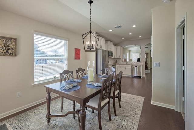 dining room with visible vents, baseboards, recessed lighting, arched walkways, and dark wood-type flooring