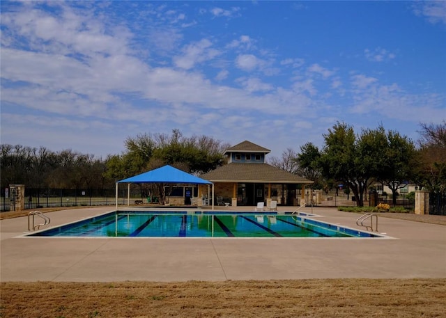 community pool featuring a gazebo, a patio, and fence