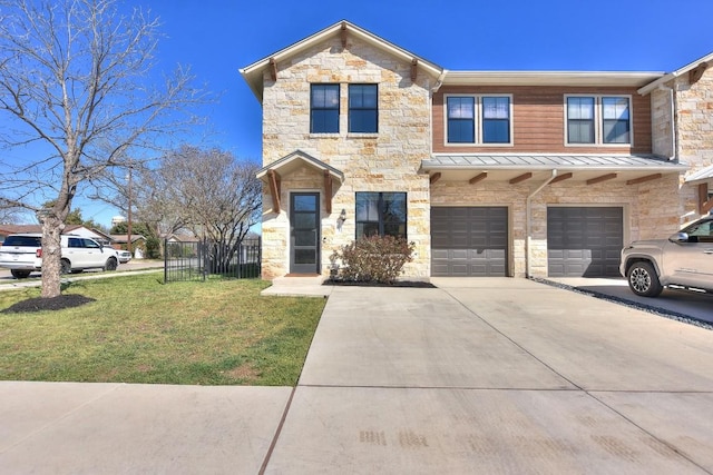 view of property with a front yard, metal roof, a garage, driveway, and a standing seam roof