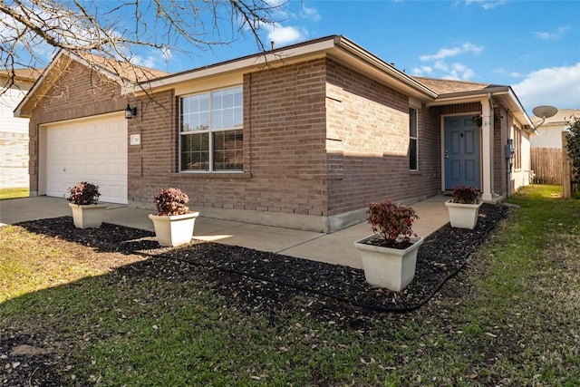 view of side of property with brick siding, a lawn, driveway, and a garage