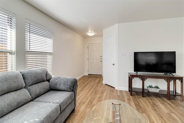 living room with light wood-style flooring and baseboards