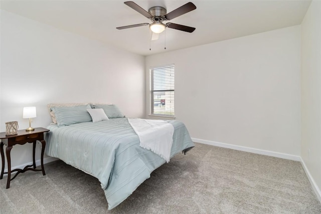 bedroom with a ceiling fan, light colored carpet, and baseboards