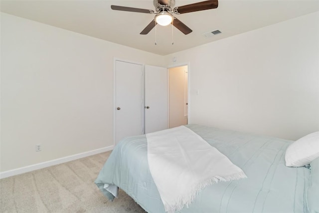 bedroom featuring visible vents, a ceiling fan, baseboards, and carpet floors