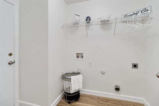 washroom featuring wood finished floors, gas dryer hookup, laundry area, electric dryer hookup, and washer hookup