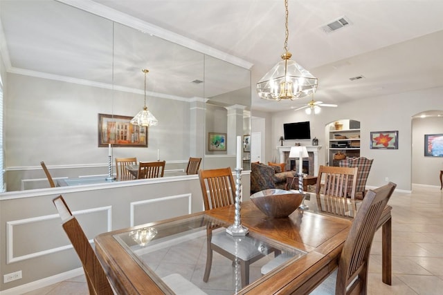 dining room with arched walkways, visible vents, a fireplace, and light tile patterned floors