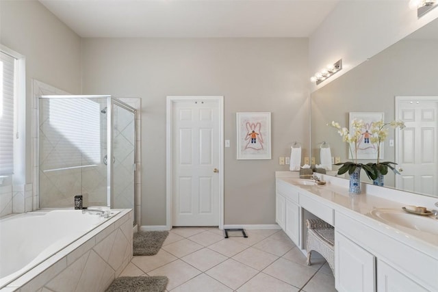 full bath featuring a sink, a bath, a shower stall, and tile patterned flooring