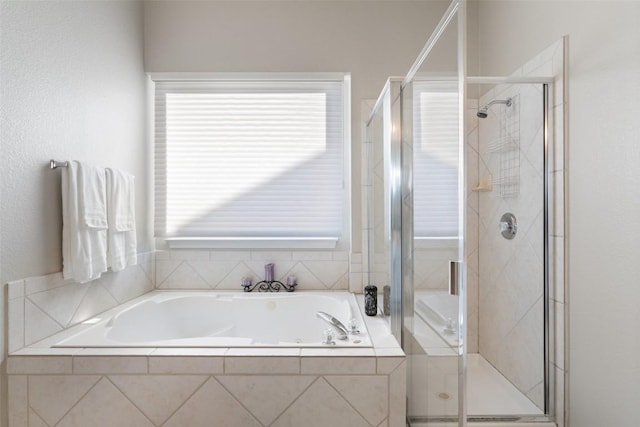 full bathroom featuring a stall shower and a bath