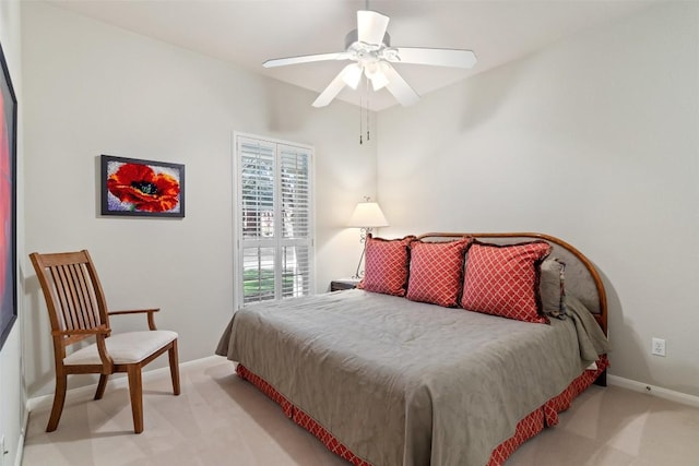 bedroom with light carpet, ceiling fan, and baseboards