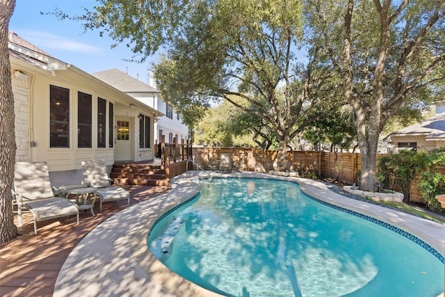 view of pool with a fenced backyard, a fenced in pool, and a wooden deck