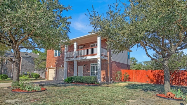 view of front of home featuring a balcony, fence, a front lawn, a garage, and brick siding