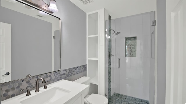 full bath featuring visible vents, toilet, a shower stall, decorative backsplash, and vanity