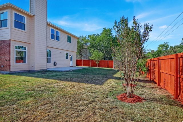 view of yard with a patio area and a fenced backyard