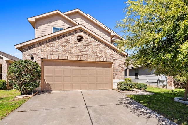 view of front of property featuring a garage, brick siding, and driveway