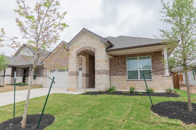 view of front facade featuring a front lawn, concrete driveway, a garage, and roof with shingles